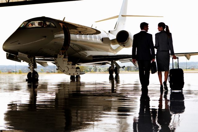 Two business people walking to a jet plane
