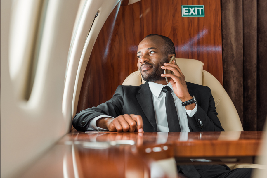 Man in a private jet talking on the phone
